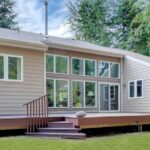 Home with windows and deck in the forest